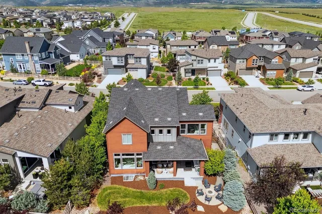 an aerial view of residential houses with outdoor space and swimming pool