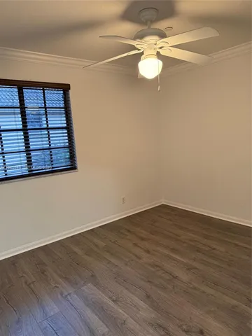 a view of a room with wooden floor and white walls