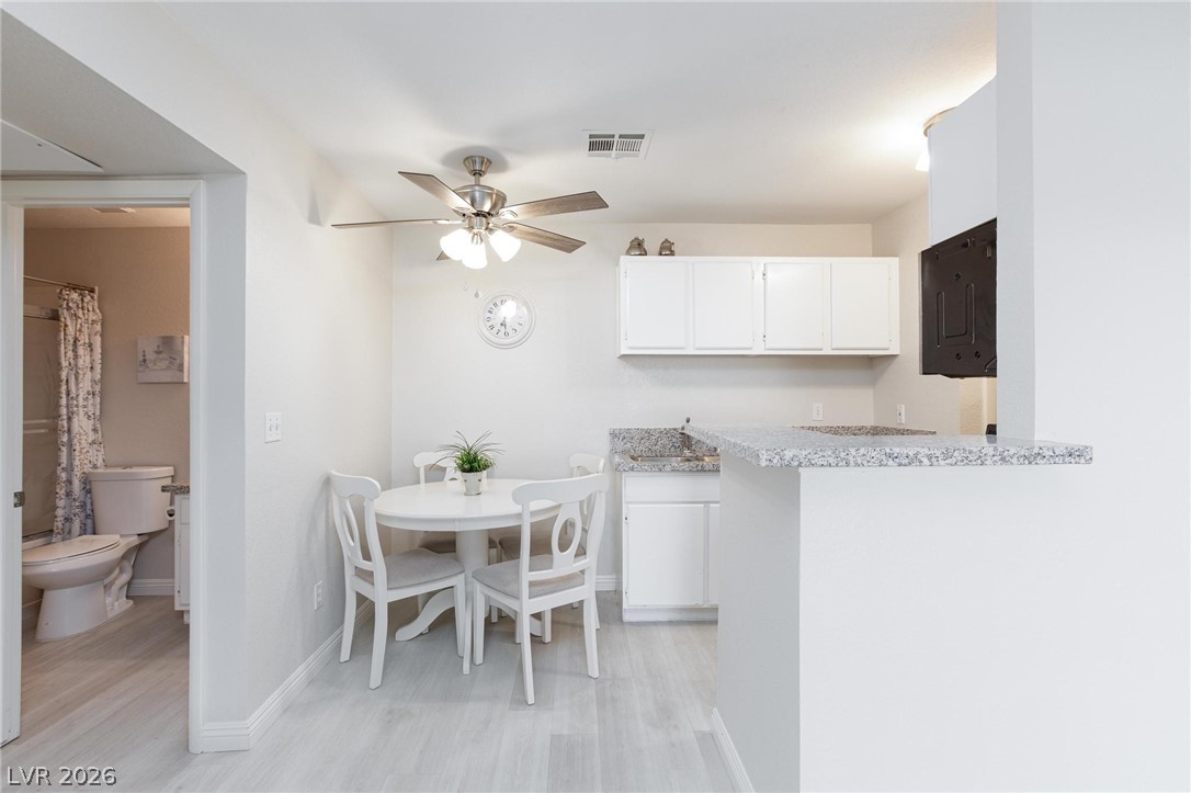 5171 South Lindell Road, Unit 103 Las Vegas, NV 89118 - Photo 9 of 24 Bright dining area with stylish wood flooring flows seamlessly into the kitchen space.