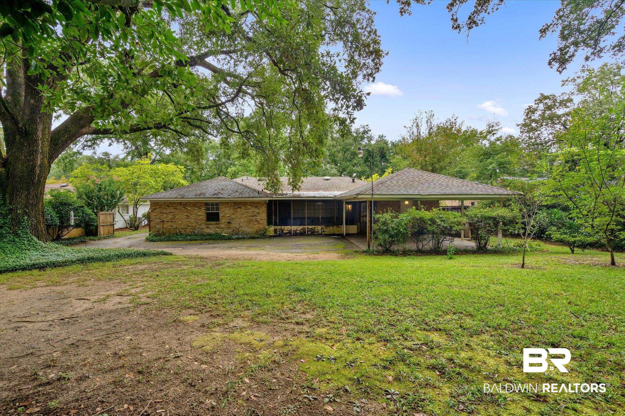 6657 Hounds Run South Mobile, AL 36608 - Photo 19 of 20 Rear view of house with a yard and a patio area
