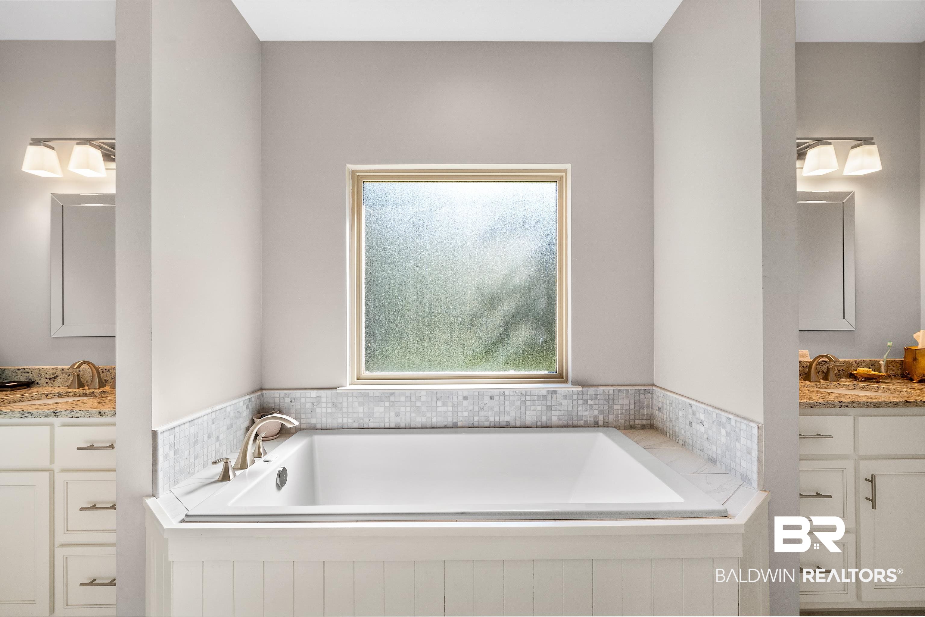 29530 St John Street Daphne, AL 36526 - Photo 17 of 38 Bathroom featuring tiled tub, vanity, and plenty of natural light