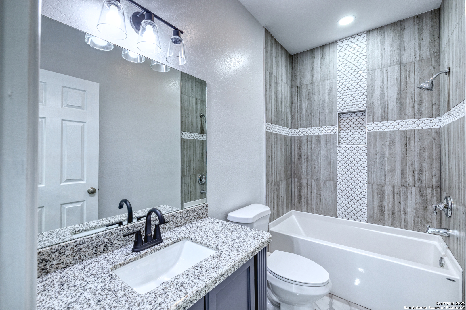 44 Sunday Court Uvalde, TX 78801 - Photo 15 of 30 a bathroom with a granite countertop sink a toilet a mirror and shower