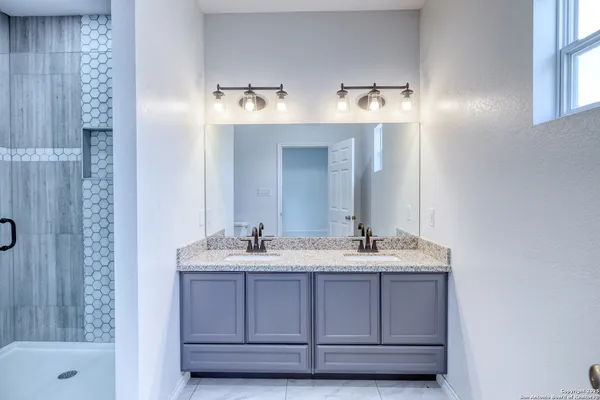 a bathroom with a sink and a mirror