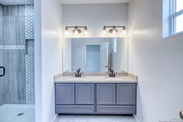 a bathroom with a sink and a mirror
