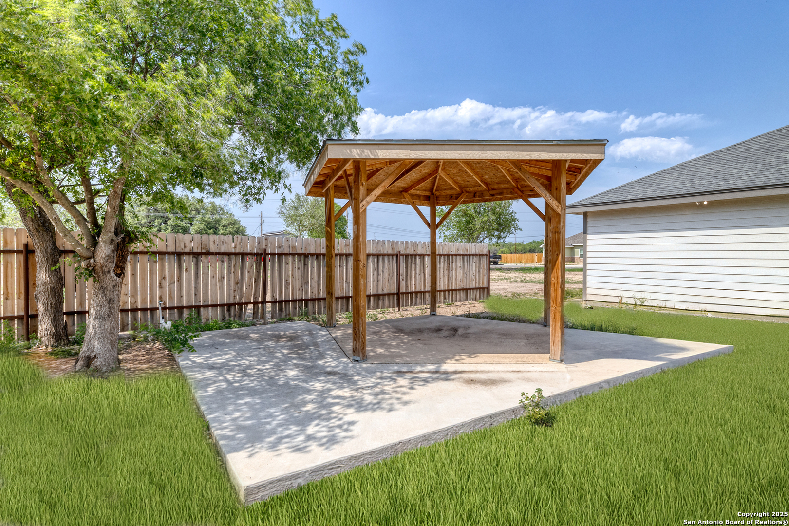 44 Sunday Court Uvalde, TX 78801 - Photo 25 of 30 a view of a backyard with a table and chairs under an umbrella