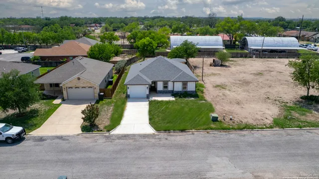 an aerial view of a house with a garden and plants