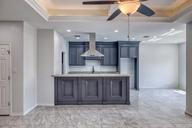a view of a kitchen with a sink and chandelier