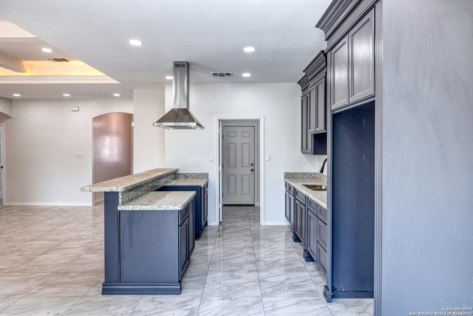 44 Sunday Court Uvalde, TX 78801 - Photo 5 of 30 a kitchen with stainless steel appliances granite countertop a stove a sink and a refrigerator