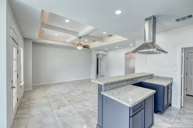 a kitchen with granite countertop a sink and a stove