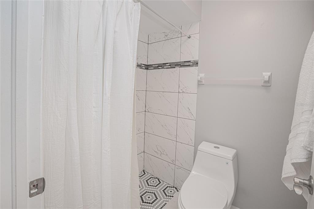 24540 Harbor View Road, Unit D3 Punta Gorda, FL 33980 - Photo 23 of 33 a bathroom with a toilet and a shower