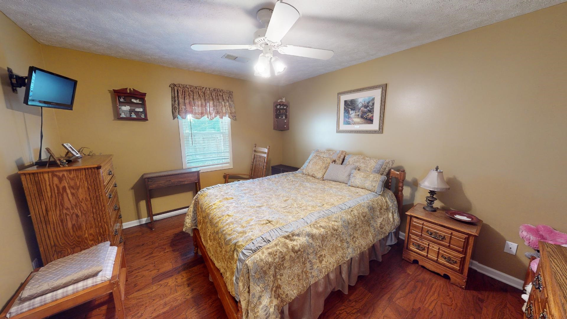 4395 Hamer Road Newbern, TN 38059 - Photo 7 of 20 a bedroom with a bed and wooden floor