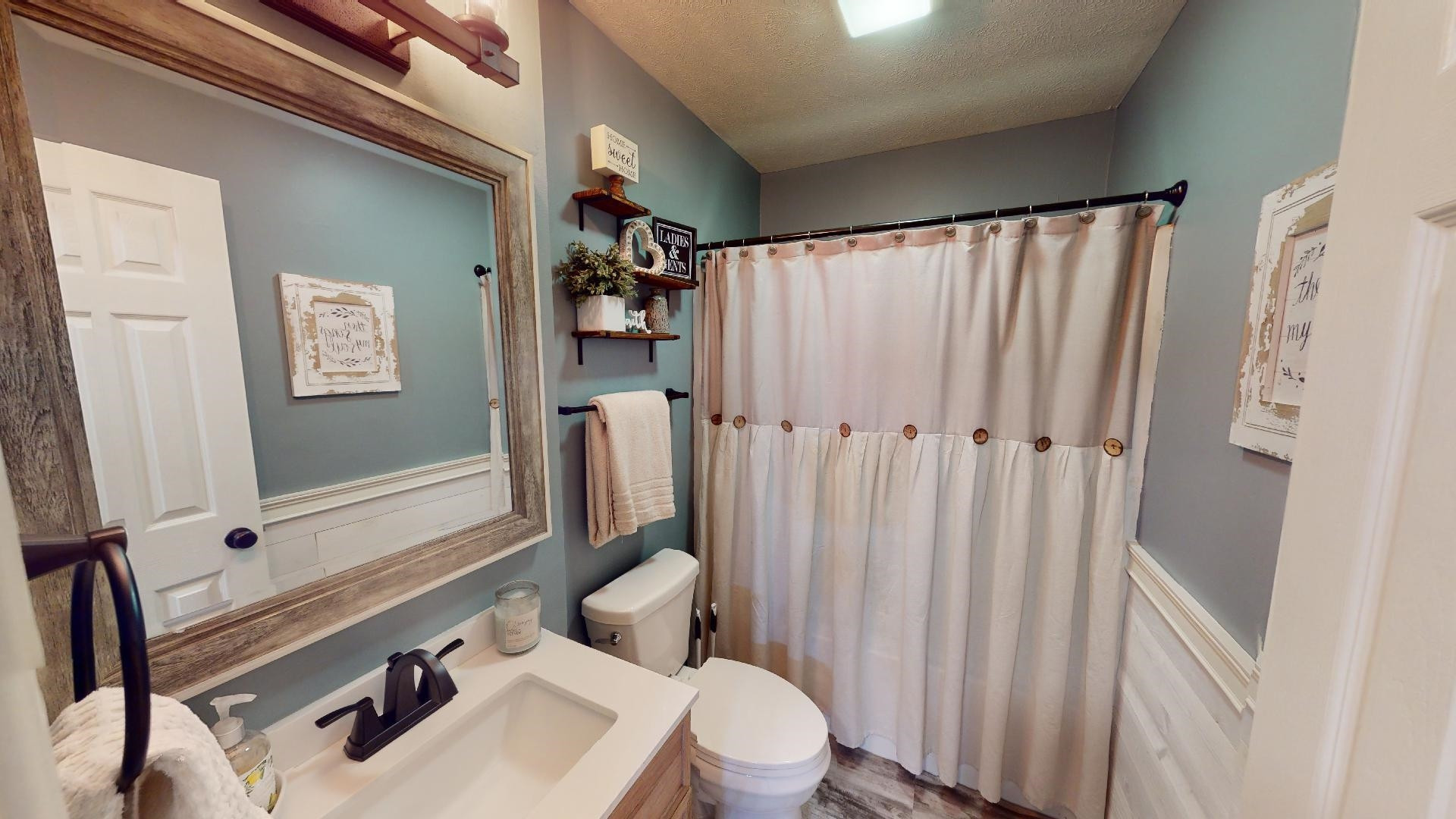 4395 Hamer Road Newbern, TN 38059 - Photo 8 of 20 a bathroom with a sink a toilet and shower curtain
