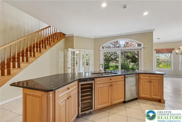 a kitchen with stainless steel appliances granite countertop a refrigerator and a stove