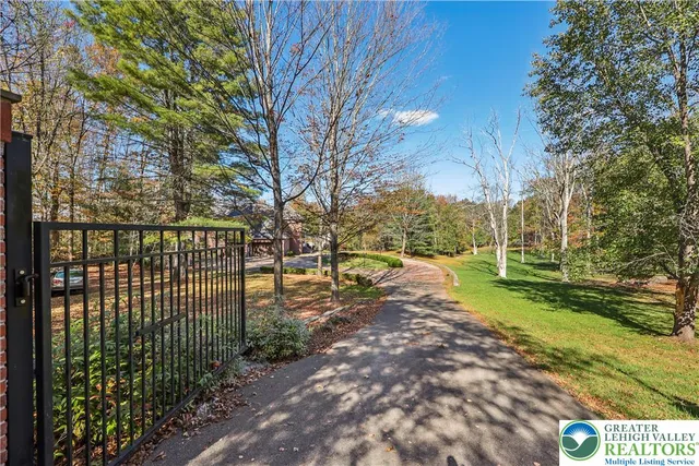 an aerial view of a house with a yard and large trees