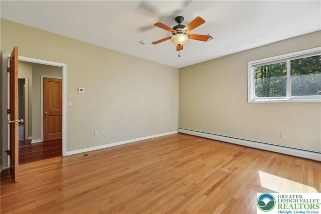 a spacious bathroom with a granite countertop sink mirror and double