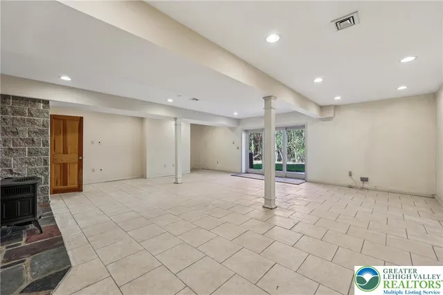 a view of an empty room with brick wall and a window