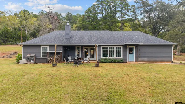 a aerial view of a house next to a big yard