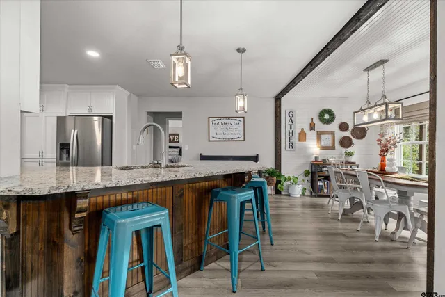 a large kitchen with granite countertop a large island in the center