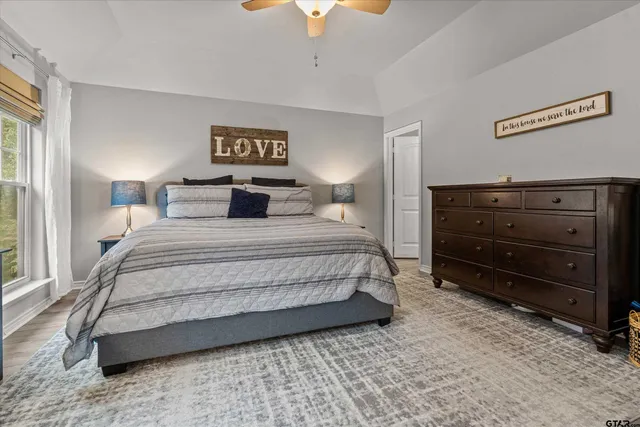 a bedroom with a bed and a chandelier