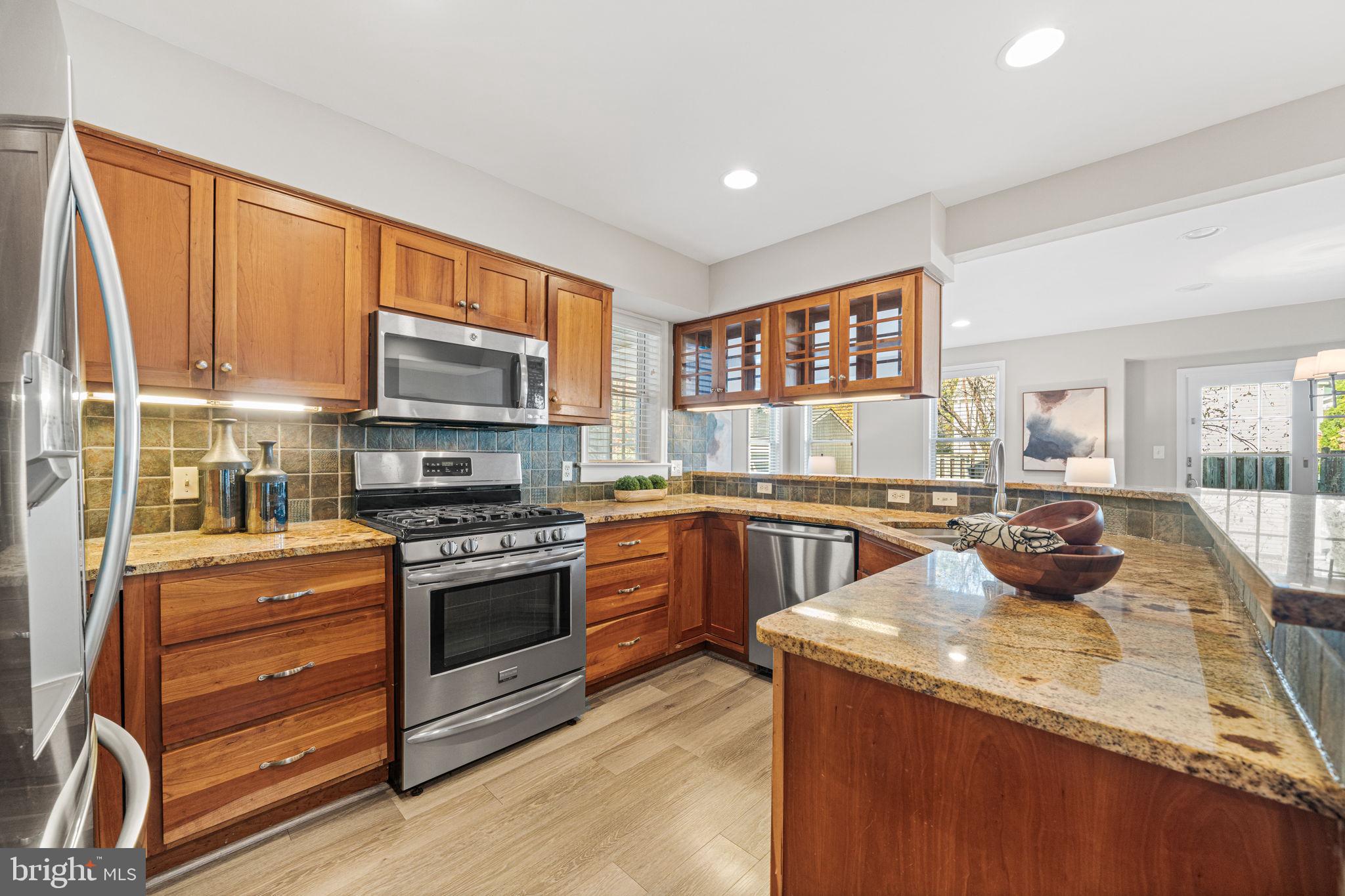 4613 8th Road South Arlington, VA 22204 - Photo 15 of 59 a kitchen with stainless steel appliances granite countertop a stove a sink and a refrigerator