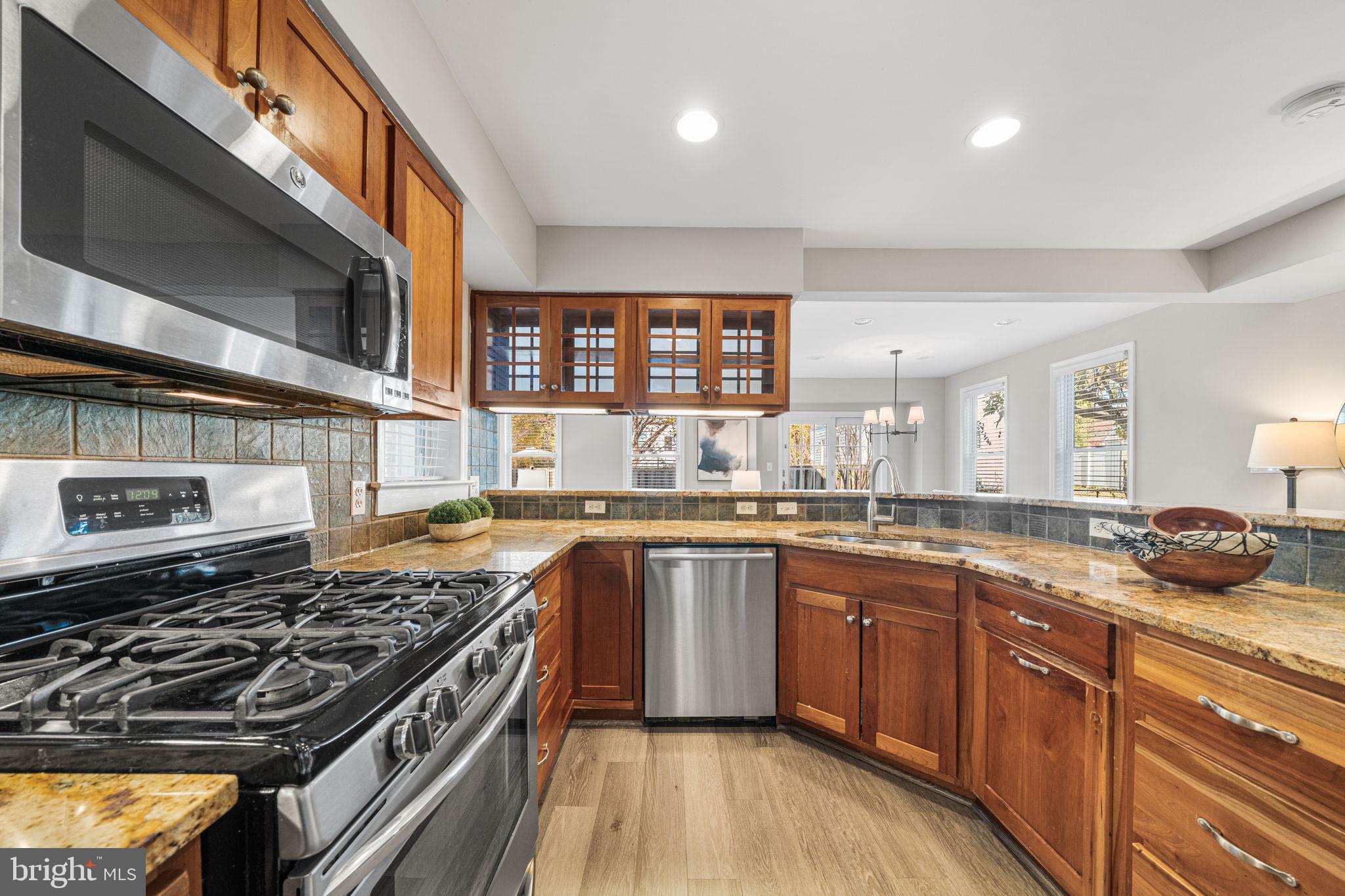 4613 8th Road South Arlington, VA 22204 - Photo 16 of 59 a large kitchen with stainless steel appliances granite countertop a stove and a sink