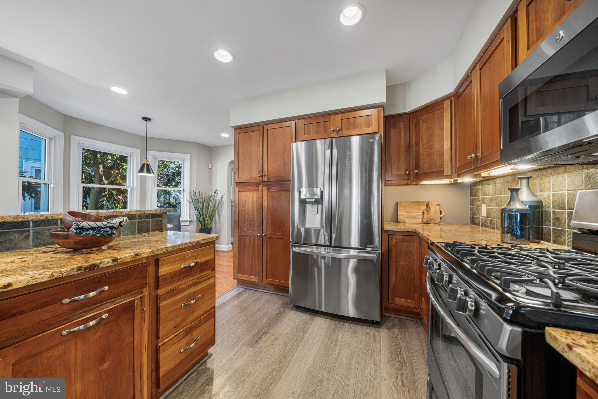 4613 8th Road South Arlington, VA 22204 - Photo 17 of 59 a kitchen with a refrigerator a sink and wooden floor