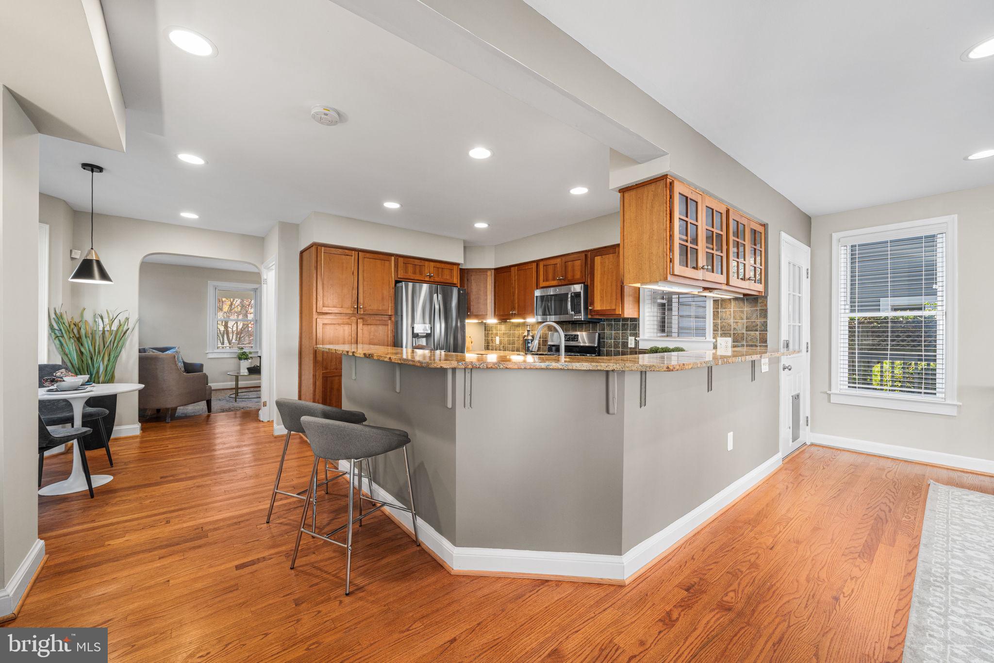 4613 8th Road South Arlington, VA 22204 - Photo 19 of 59 a living room with stainless steel appliances kitchen island granite countertop furniture and a wooden floor