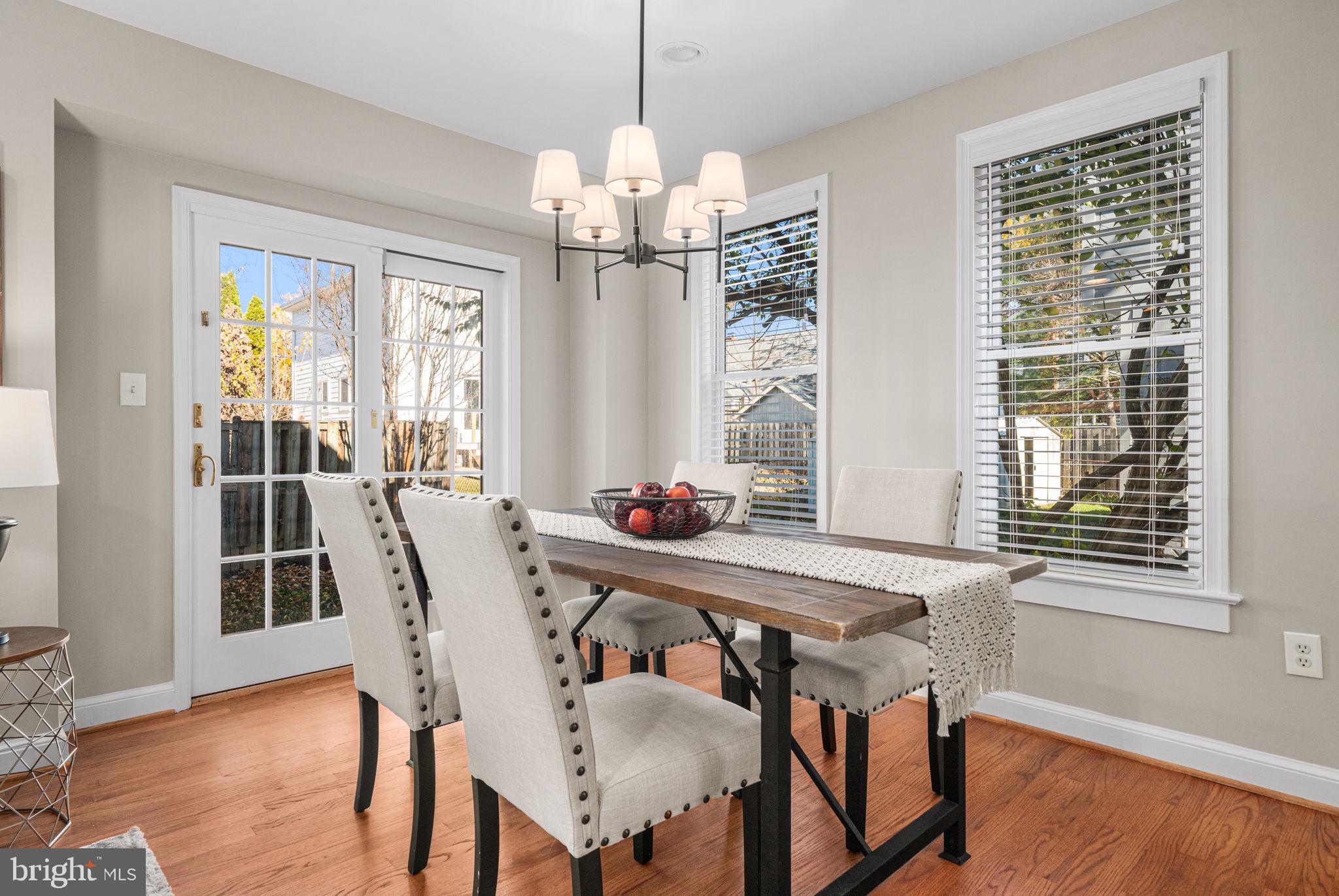 4613 8th Road South Arlington, VA 22204 - Photo 21 of 59 a view of a dining room with furniture a chandelier and wooden floor