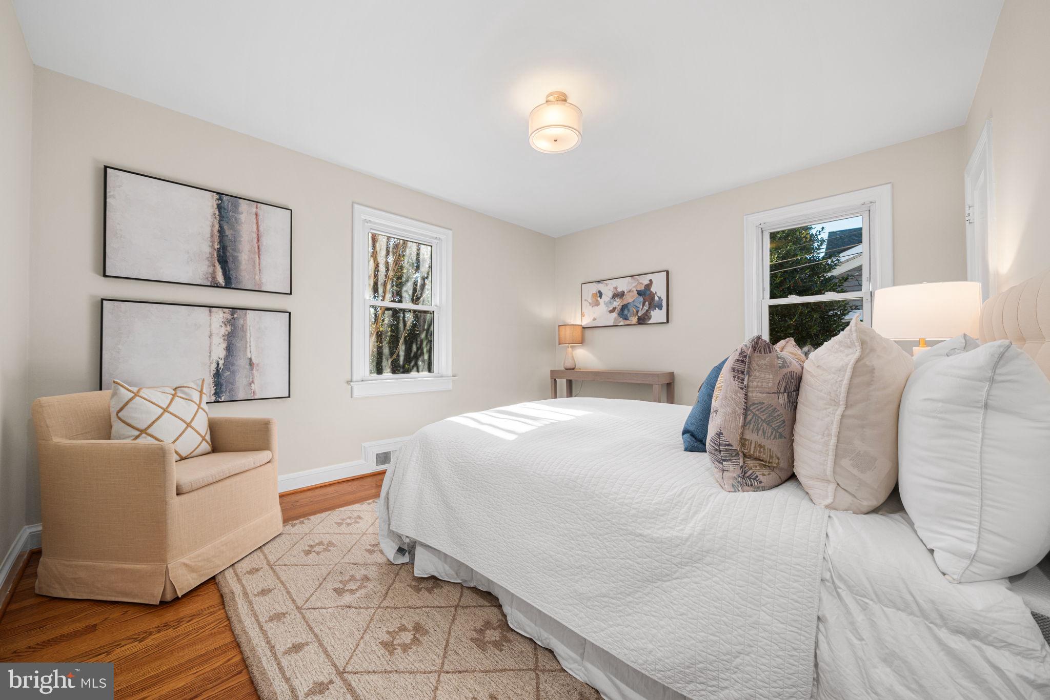 4613 8th Road South Arlington, VA 22204 - Photo 27 of 59 a bedroom with a large bed couch and windows