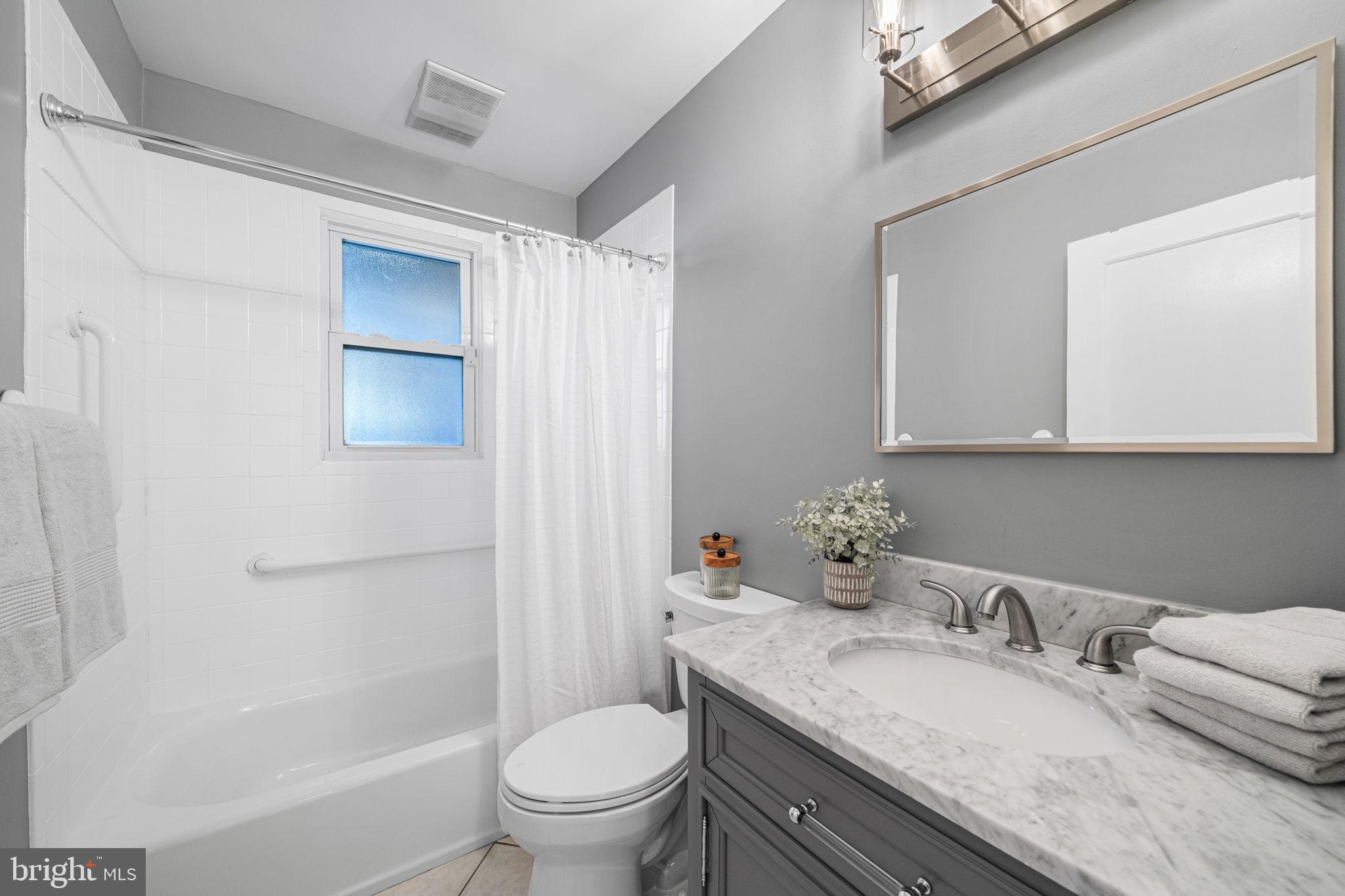 4613 8th Road South Arlington, VA 22204 - Photo 28 of 59 a bathroom with a granite countertop sink mirror vanity and toilet