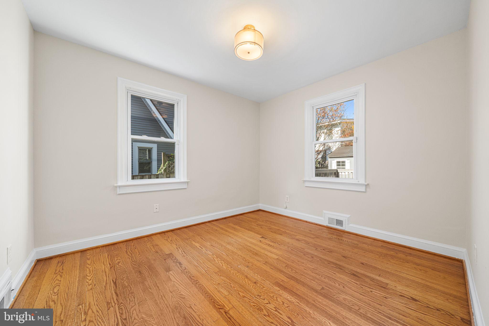 4613 8th Road South Arlington, VA 22204 - Photo 29 of 59 a view of an empty room with a window and wooden floor