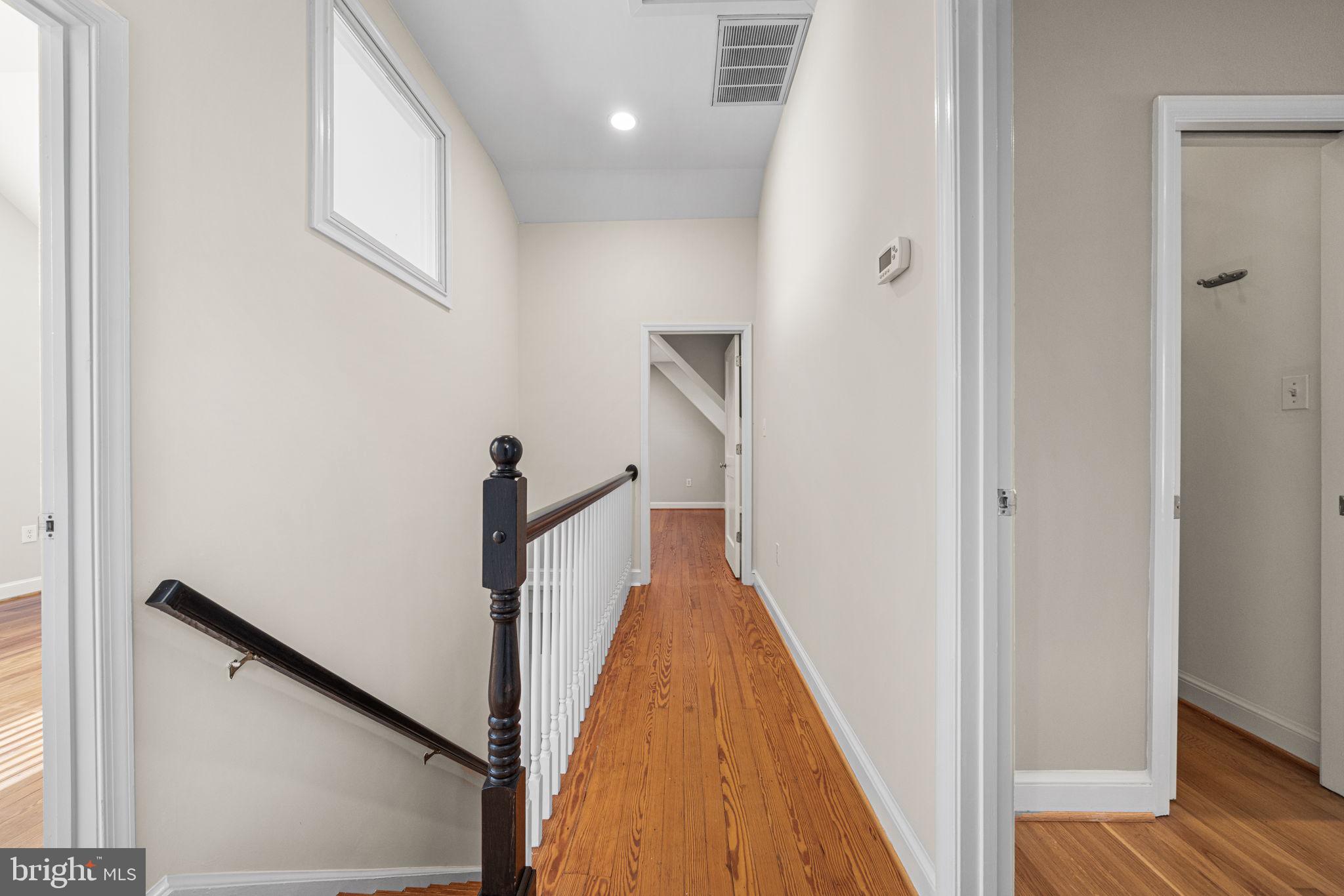 4613 8th Road South Arlington, VA 22204 - Photo 36 of 59 a view of a hallway with wooden floor and staircase