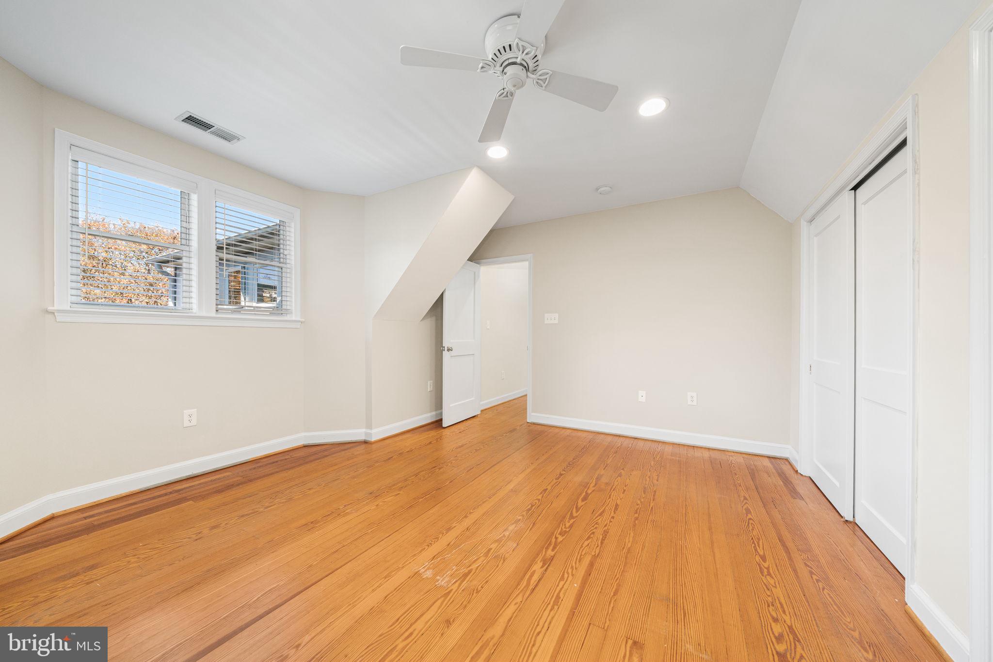 4613 8th Road South Arlington, VA 22204 - Photo 46 of 59 a view of an empty room with wooden floor and a window