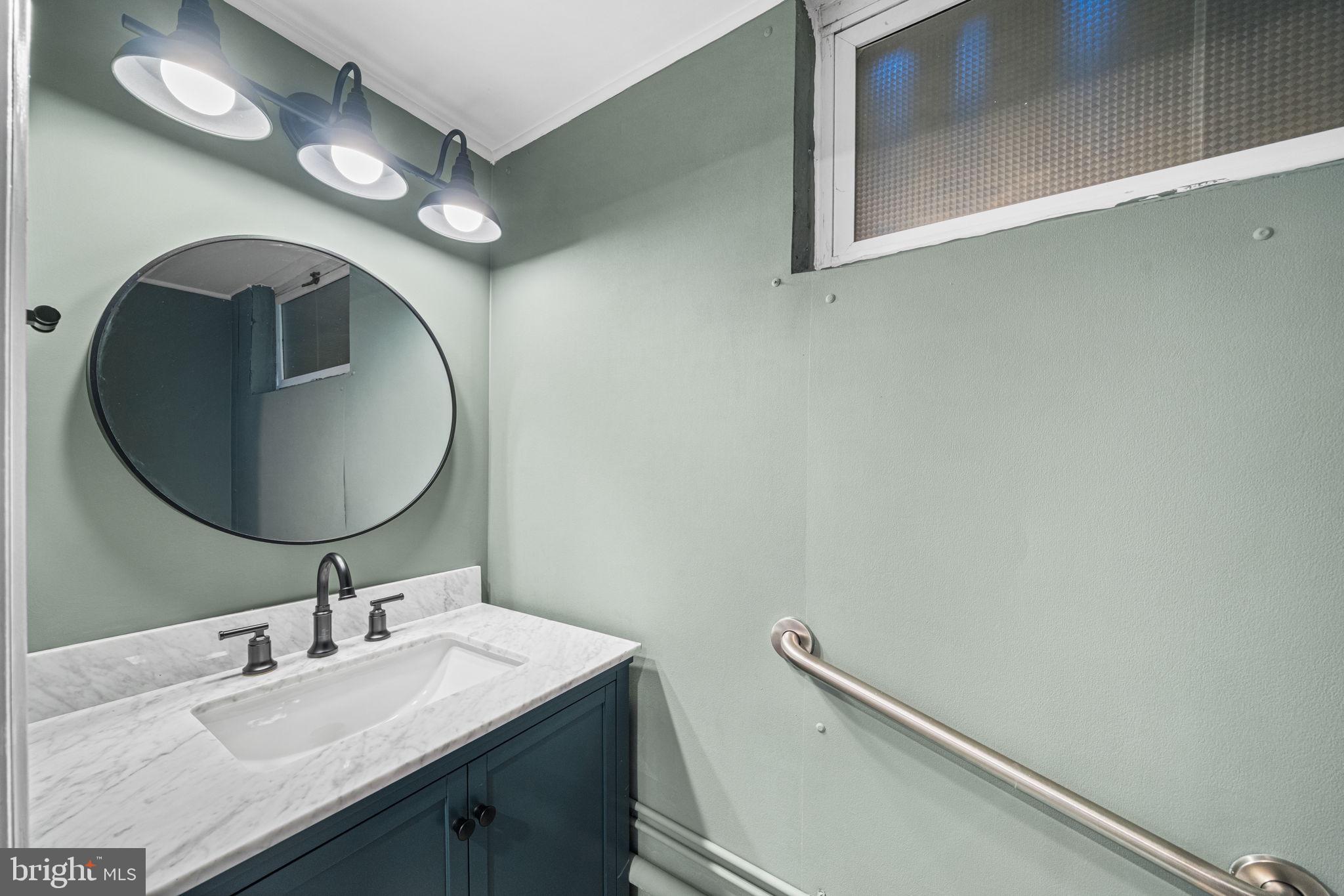4613 8th Road South Arlington, VA 22204 - Photo 50 of 59 a bathroom with a sink and a mirror