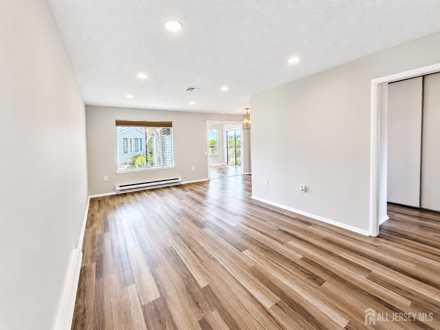 621 A Deal Road Monroe Township, NJ 08831 - Photo 4 of 27 an empty room with wooden floor and windows