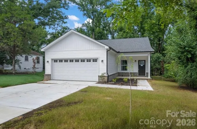 a front view of house with yard and green space