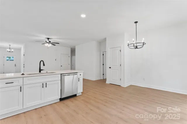a view of a kitchen with a sink cabinets and wooden floor