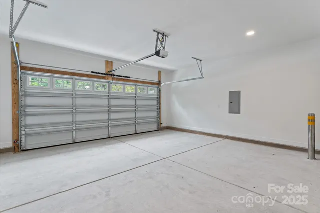 a view of a small house with a yard chairs and a tree