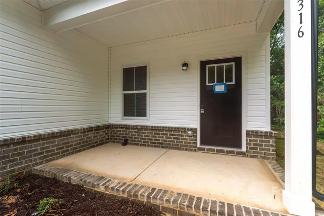 a balcony with wooden floor and outdoor seating