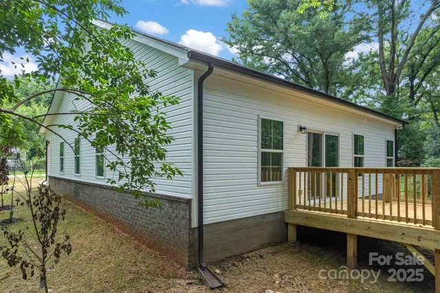 a balcony with furniture and umbrella