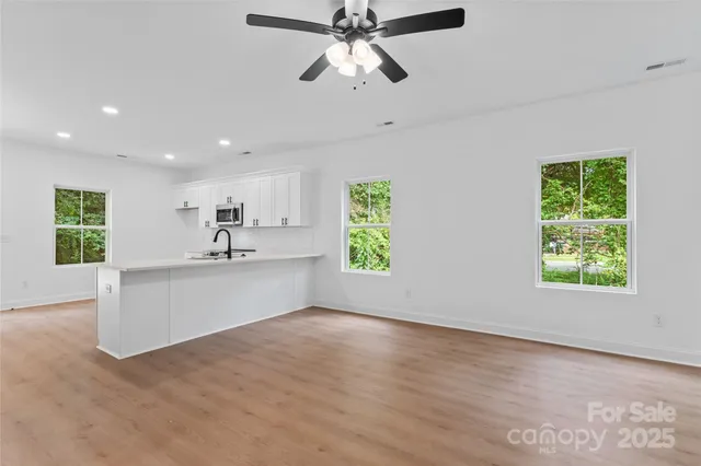 a view of a kitchen with a sink and window