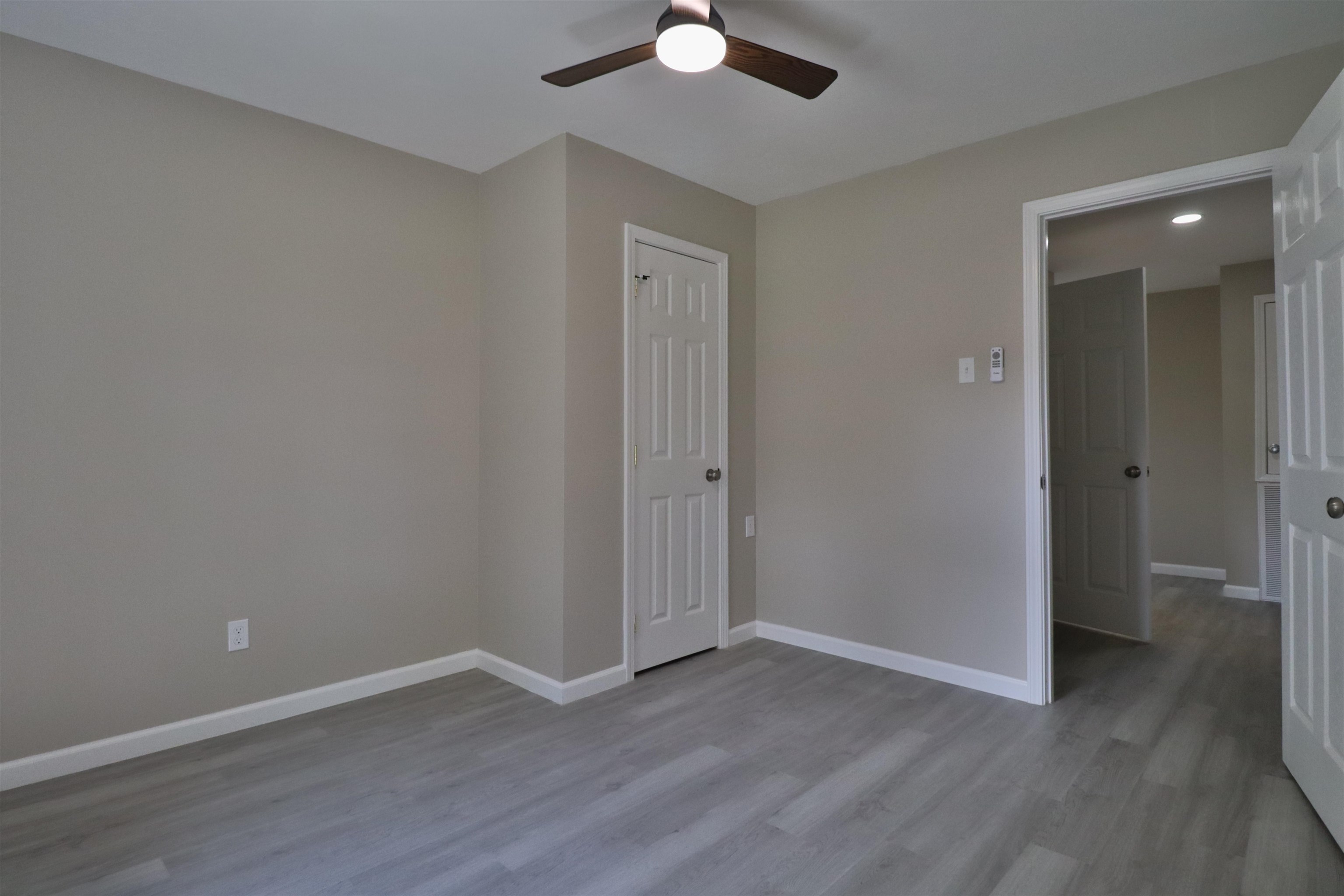 224 Kellar Avenue Ripley, TN 38063 - Photo 18 of 30 an empty room with wooden floor and a ceiling fan