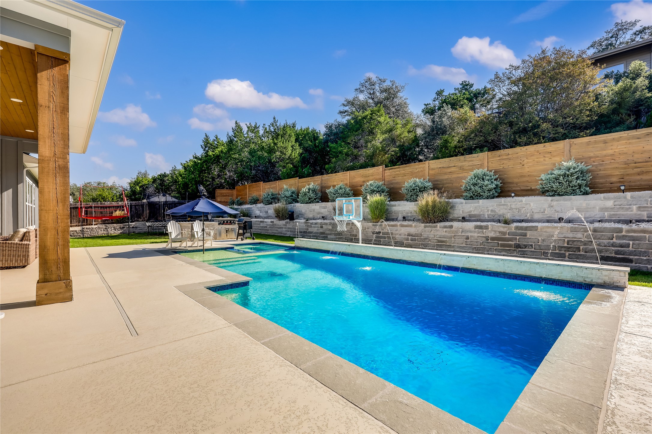 233 Lakefront Drive Lago Vista, TX 78645 - Photo 18 of 40 a view of swimming pool with seating space and trees in the background