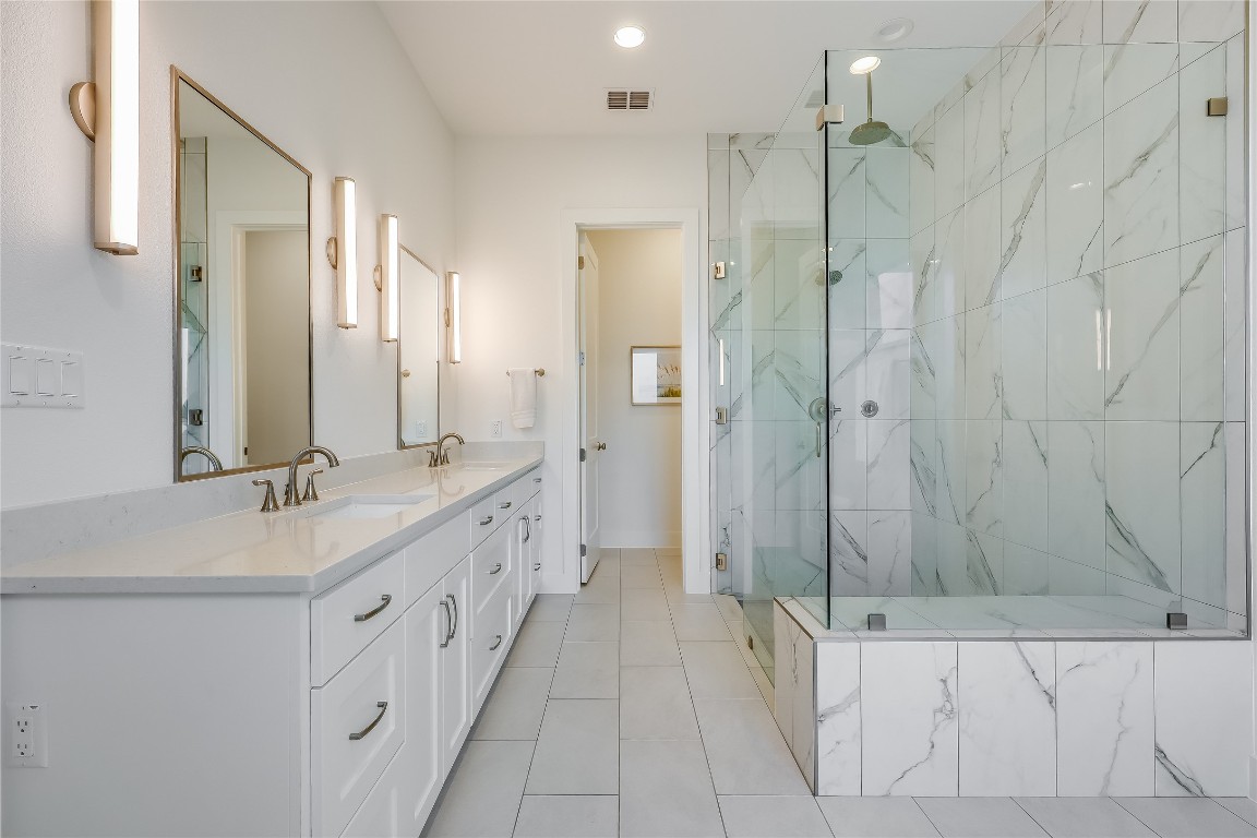 Undisclosed Address Point Venture, TX 78645 - Photo 19 of 40 a bathroom with a double vanity sink a large mirror and a shower