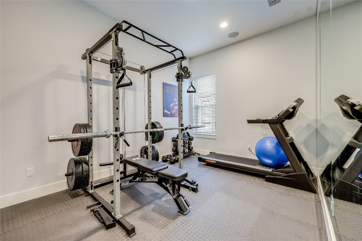 Undisclosed Address Point Venture, TX 78645 - Photo 23 of 40 a room with gym equipment and a chandelier