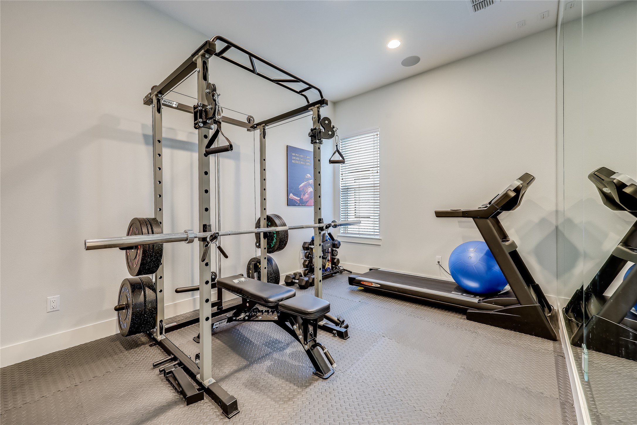 233 Lakefront Drive Lago Vista, TX 78645 - Photo 24 of 40 a room with gym equipment and a chandelier