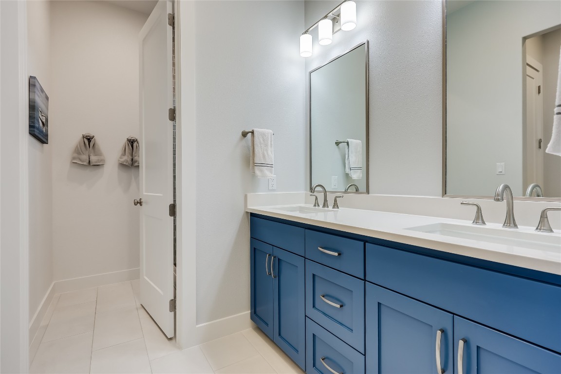 Undisclosed Address Point Venture, TX 78645 - Photo 32 of 40 a bathroom with a double vanity sink and mirror