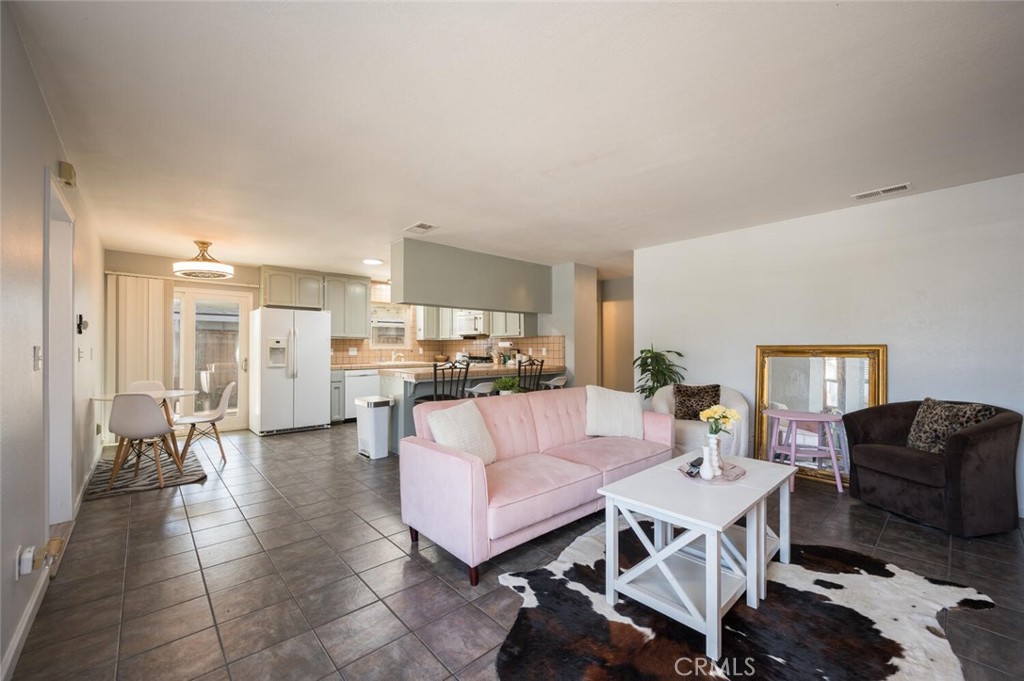 1503 17th Street Los Osos, CA 93402 - Photo 11 of 35 a living room with furniture and a dining table with kitchen view
