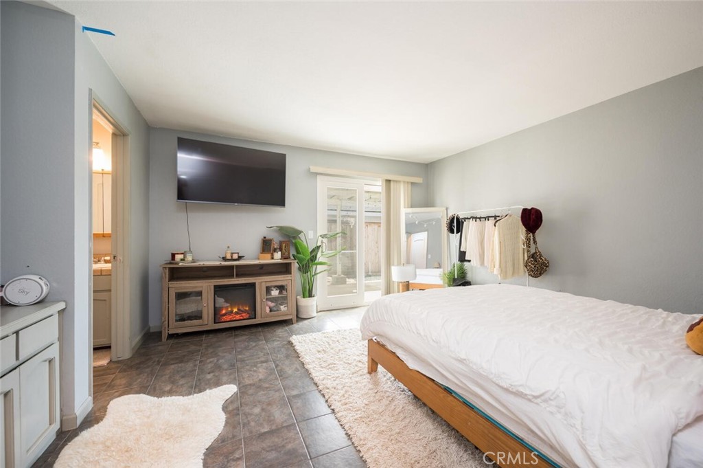 1503 17th Street Los Osos, CA 93402 - Photo 23 of 35 a bedroom with a bed and a flat screen tv