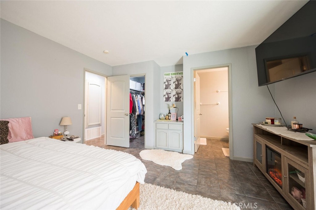 1503 17th Street Los Osos, CA 93402 - Photo 24 of 35 a bedroom with a bed and a flat screen tv